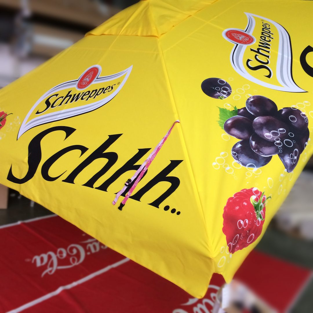schweppes branded yellow parasol