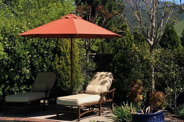 home garden parasol with sunchair on the side of the pool